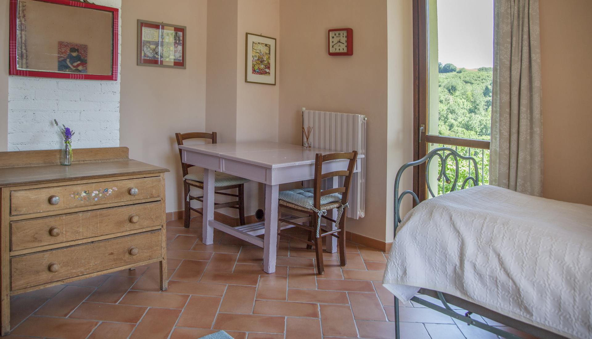 A restored wrought-iron single-bed other furnishings in La Luna suite - La Lepre Danzante